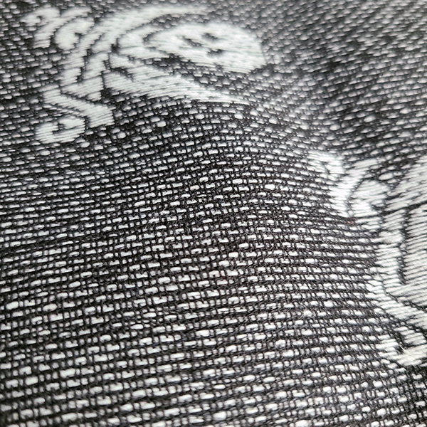 Close-up of the pirate skull and crossed swords design on the tactical shemagh scarf.