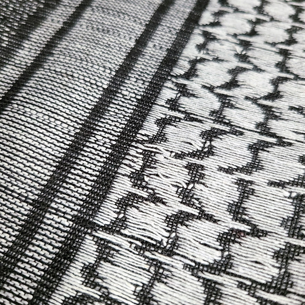 Detailed view of the houndstooth weave on the 100% cotton tactical shemagh scarf.